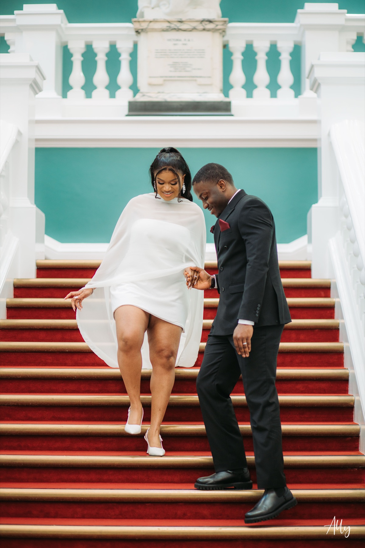 Mercy and Ifeoluwa celebrating together on the stairs